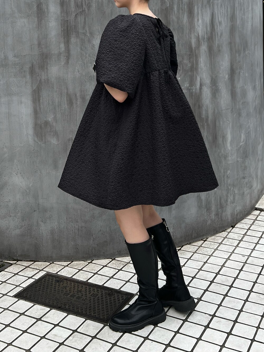 ブラック系のワンピースを着用したレディースの夏コーディネートの2枚目の写真