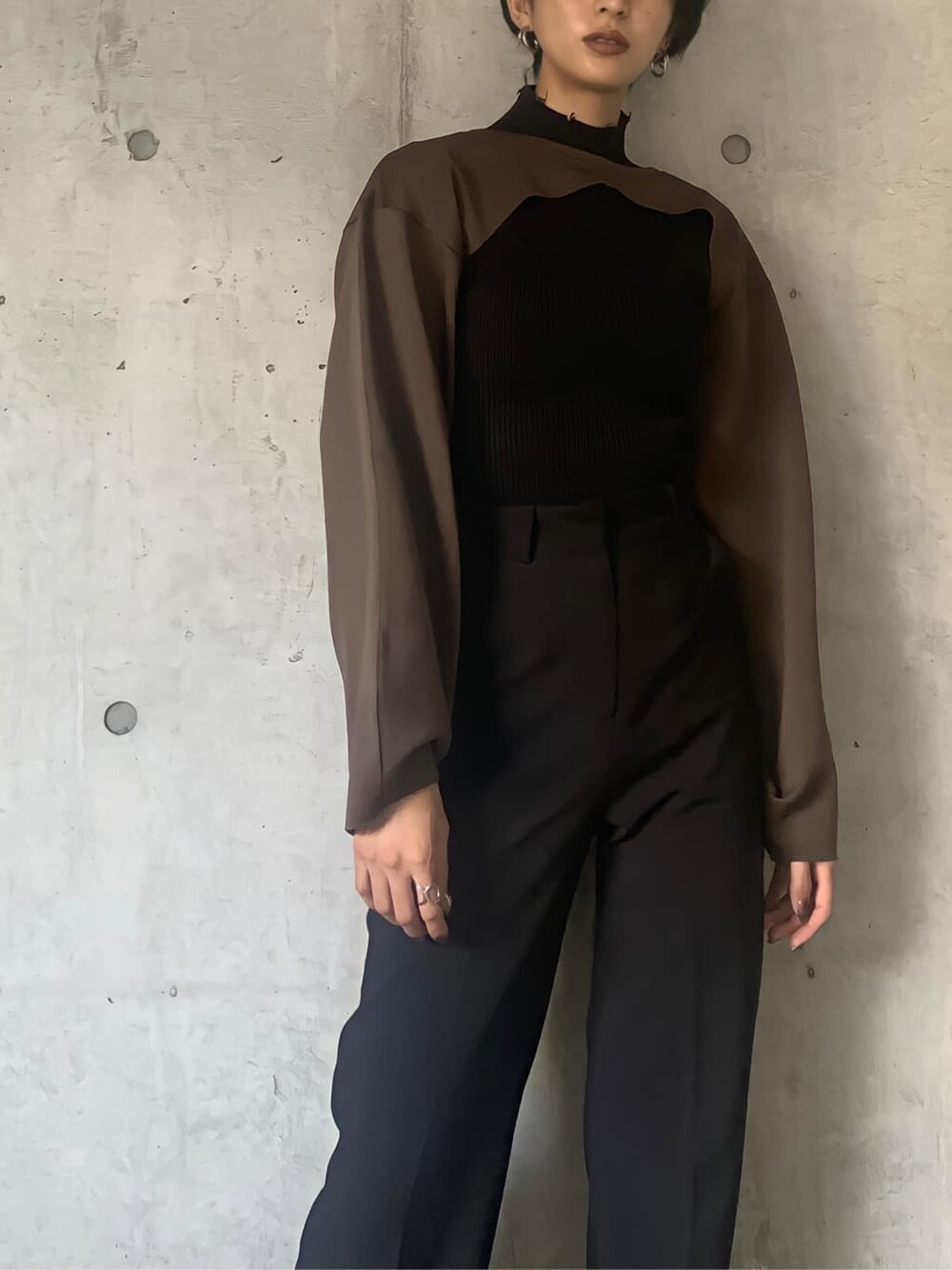 ブラック系のブーツ、ブラック系のニット/セーター、ブラウン系のTシャツ/カットソーを着用したレディースの秋コーディネートの3枚目の写真