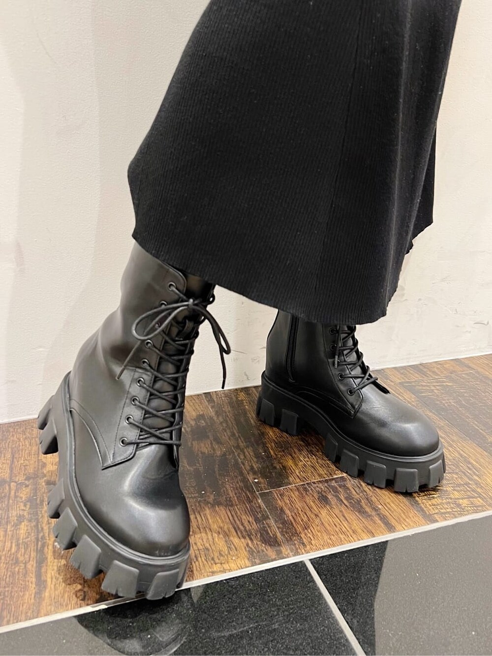 ブラック系のワンピース、ブラック系のブーツ、グレー系のブルゾンを着用したレディースの冬コーディネートの6枚目の写真