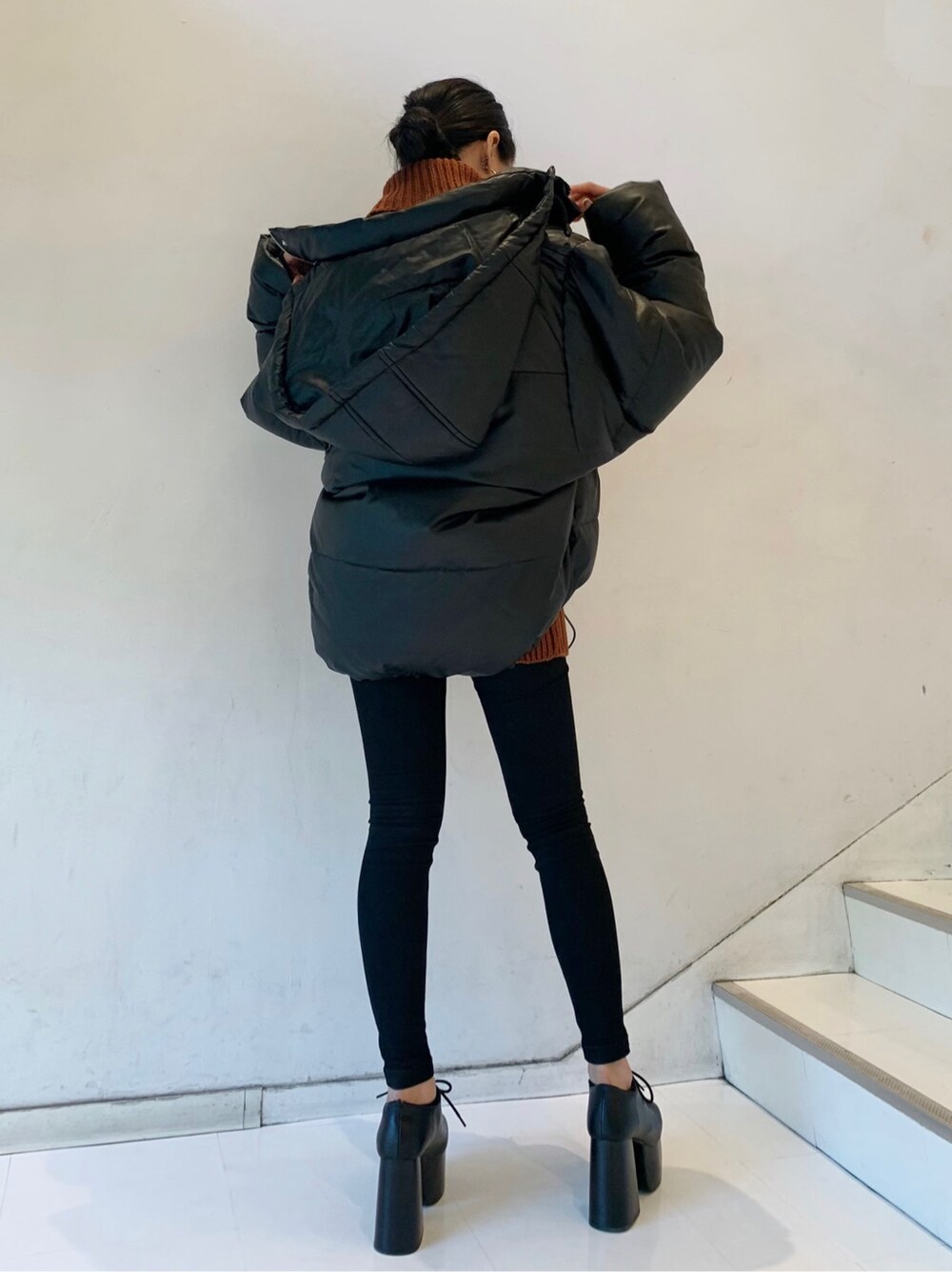 ブラウン系のニット/セーターを着用したレディースの秋コーディネートの2枚目の写真