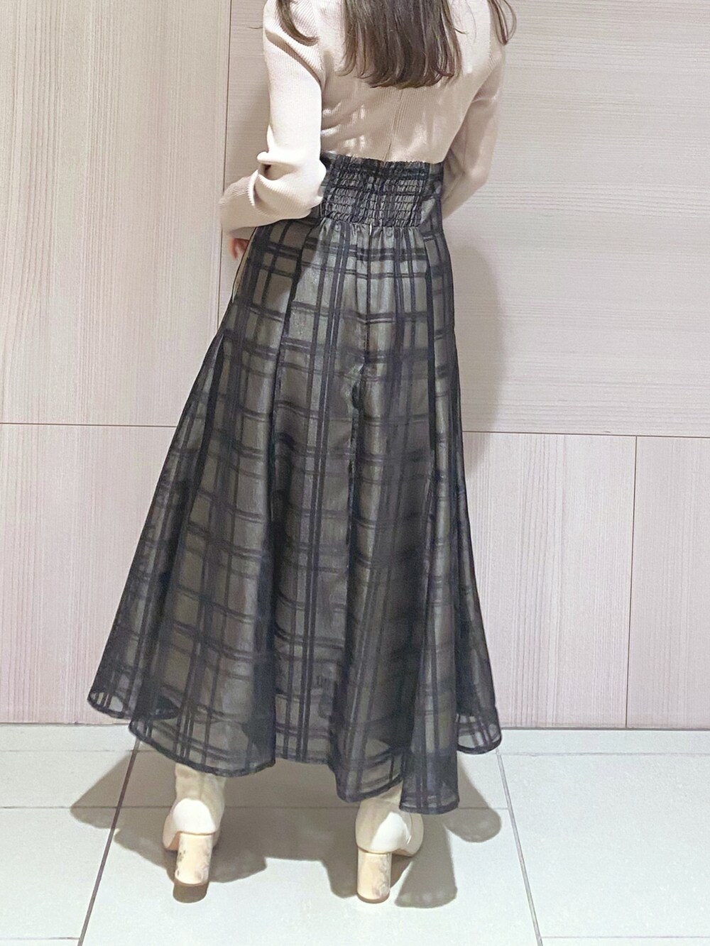 ピンク系のワンピース、ブラック系のハンドバッグ、ホワイト系のブーツを着用したレディースの秋コーディネートの8枚目の写真