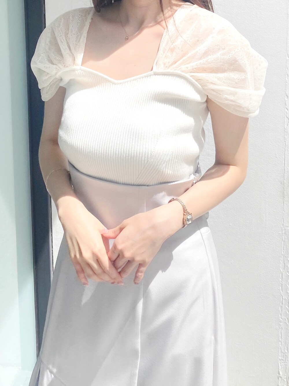 グレー系のスカート、ホワイト系のサンダル、ホワイト系のニット/セーターを着用したレディースの夏コーディネートの5枚目の写真