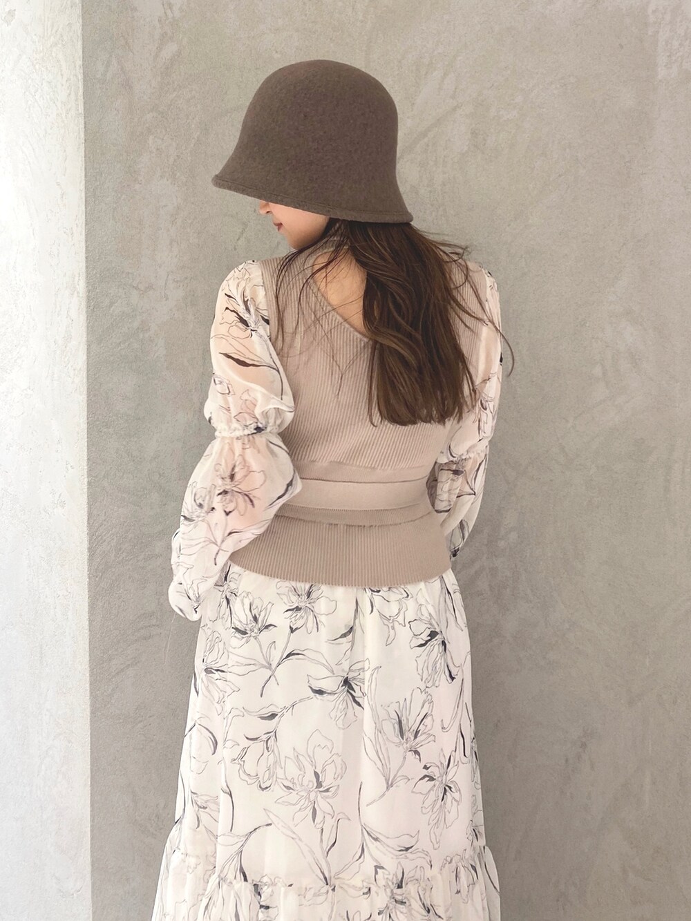 ホワイト系のワンピース、ベージュ系のハンドバッグ、ホワイト系のブーツを着用したレディースの冬コーディネートの6枚目の写真