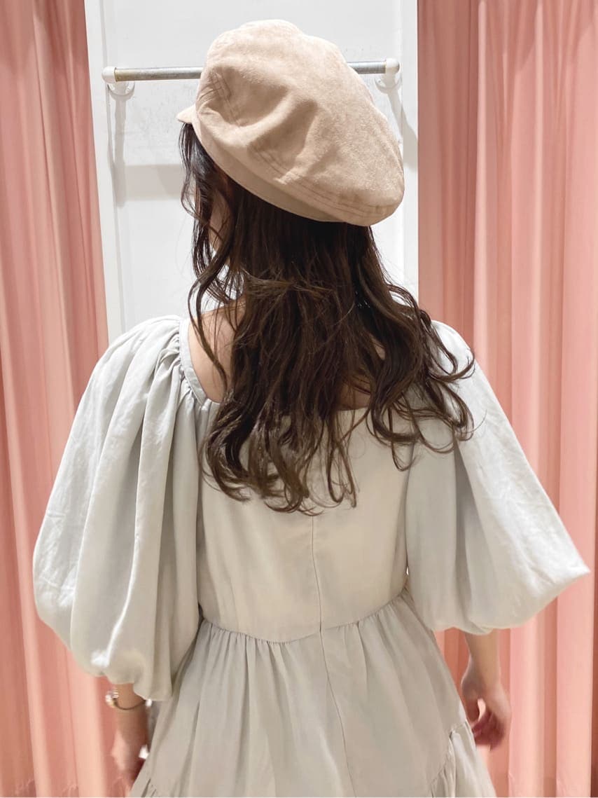 グリーン系のワンピース、ベージュ系のブーツ、ベージュ系のキャスケットを着用したレディースの秋コーディネートの5枚目の写真