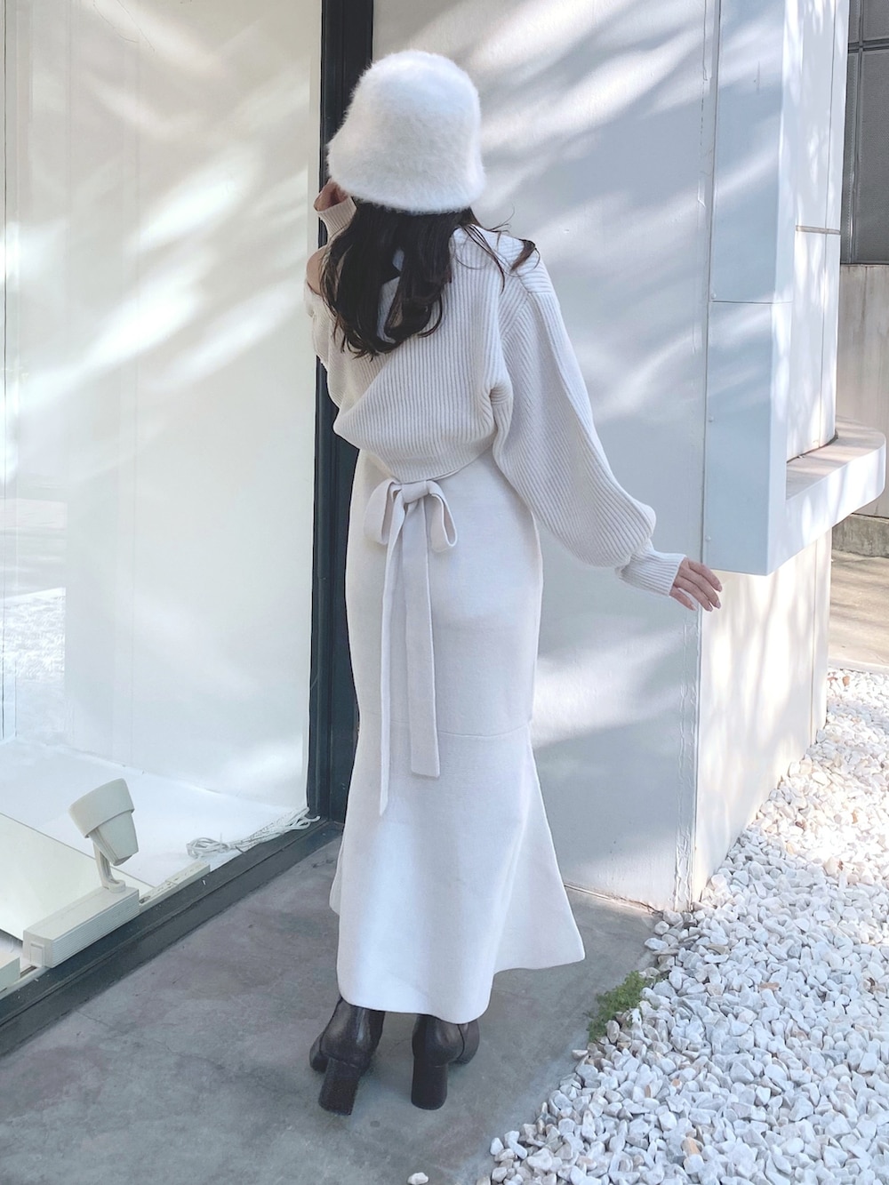 ブラウン系のブーツ、ホワイト系のワンピース、ホワイト系のハットを着用したレディースの秋コーディネートの7枚目の写真