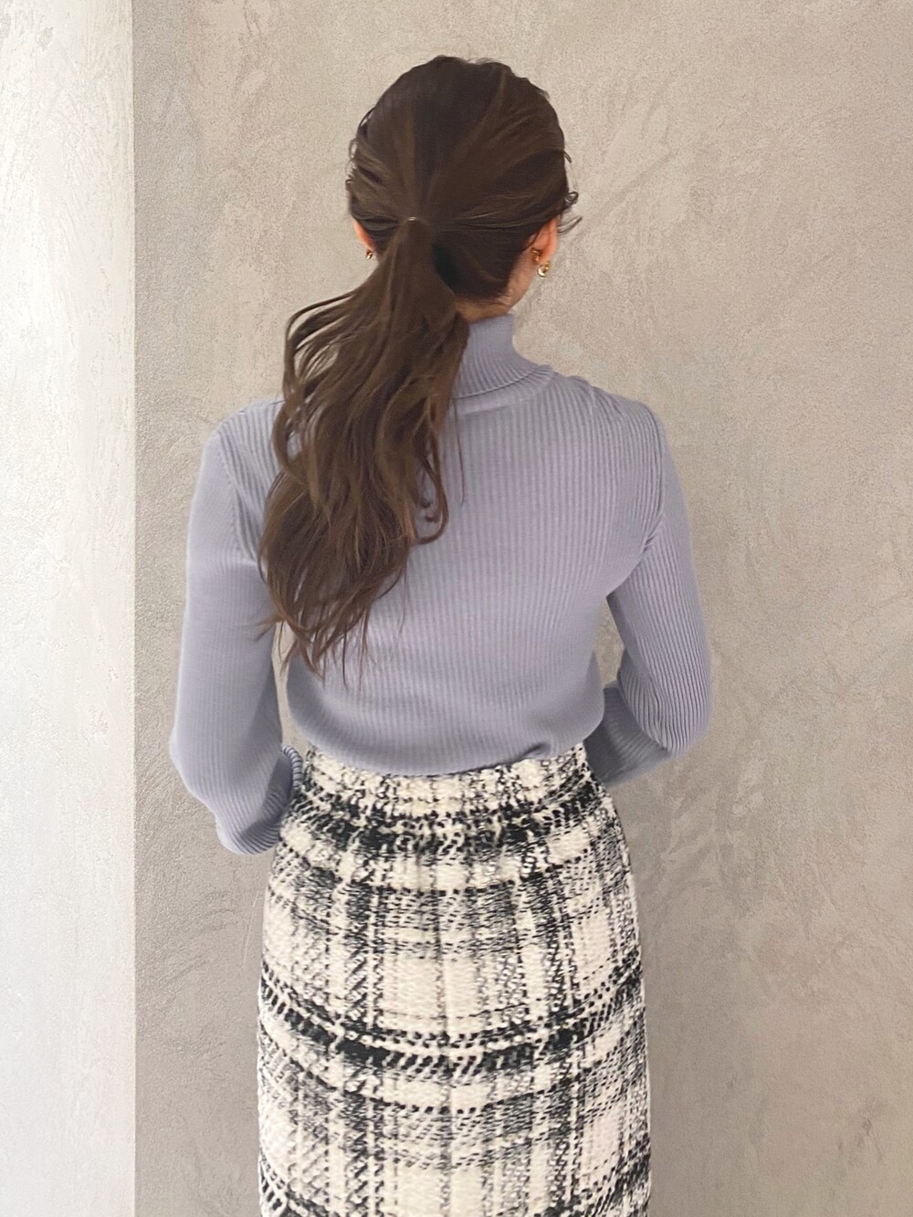 ホワイト系のブーツ、ホワイト系のスカート、ブルー系のニット/セーターを着用したレディースの冬コーディネートの7枚目の写真