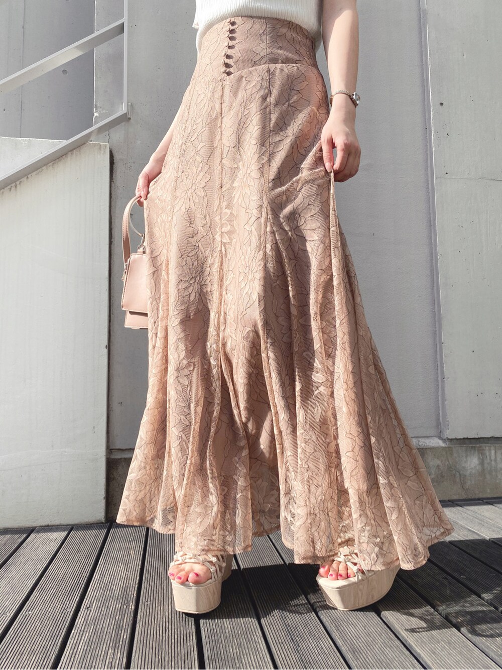 ブラウン系のスカート、ホワイト系のサンダル、ホワイト系のニット/セーターを着用したレディースの春コーディネートの5枚目の写真