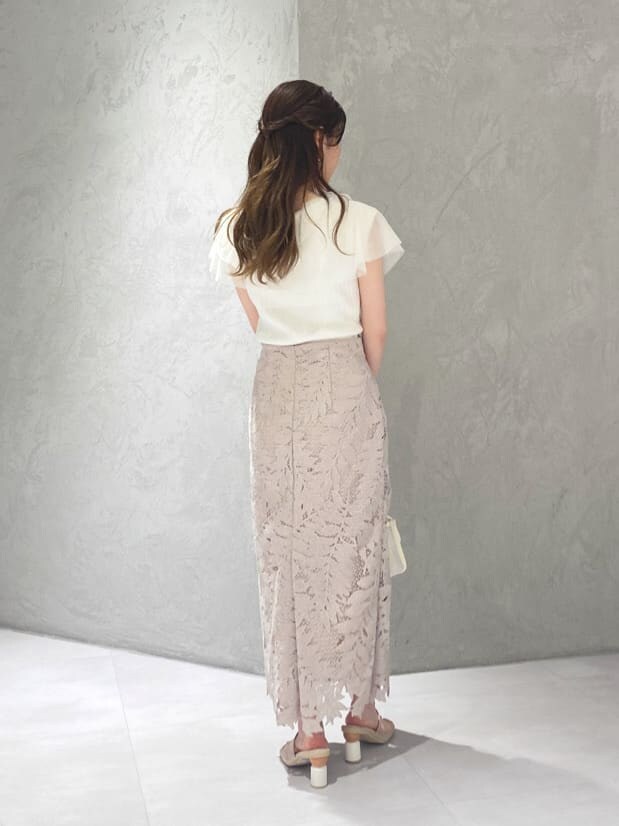 ピンク系のスカート、ベージュ系のサンダル、ホワイト系のカーディガン/ボレロを着用したレディースの夏コーディネートの6枚目の写真