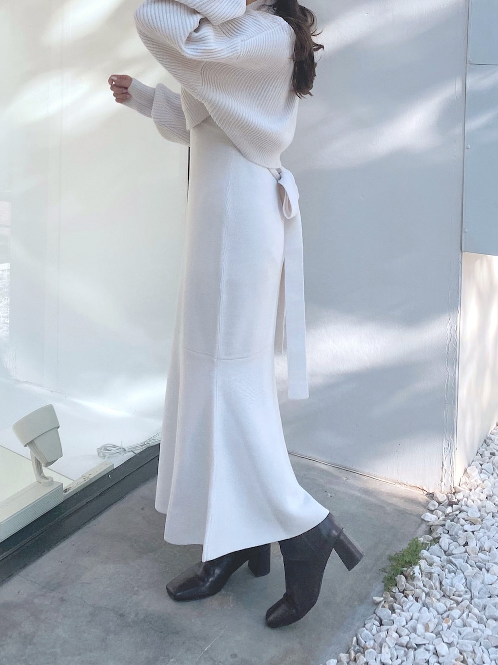 ブラウン系のブーツ、ホワイト系のワンピース、ホワイト系のハットを着用したレディースの秋コーディネートの5枚目の写真