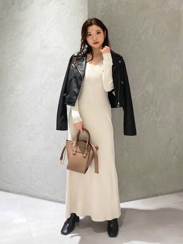 ブラック系のライダースジャケット、ブラック系のブーツ、ブラウン系のハンドバッグを着用したレディースの秋コーディネートの6枚目の写真