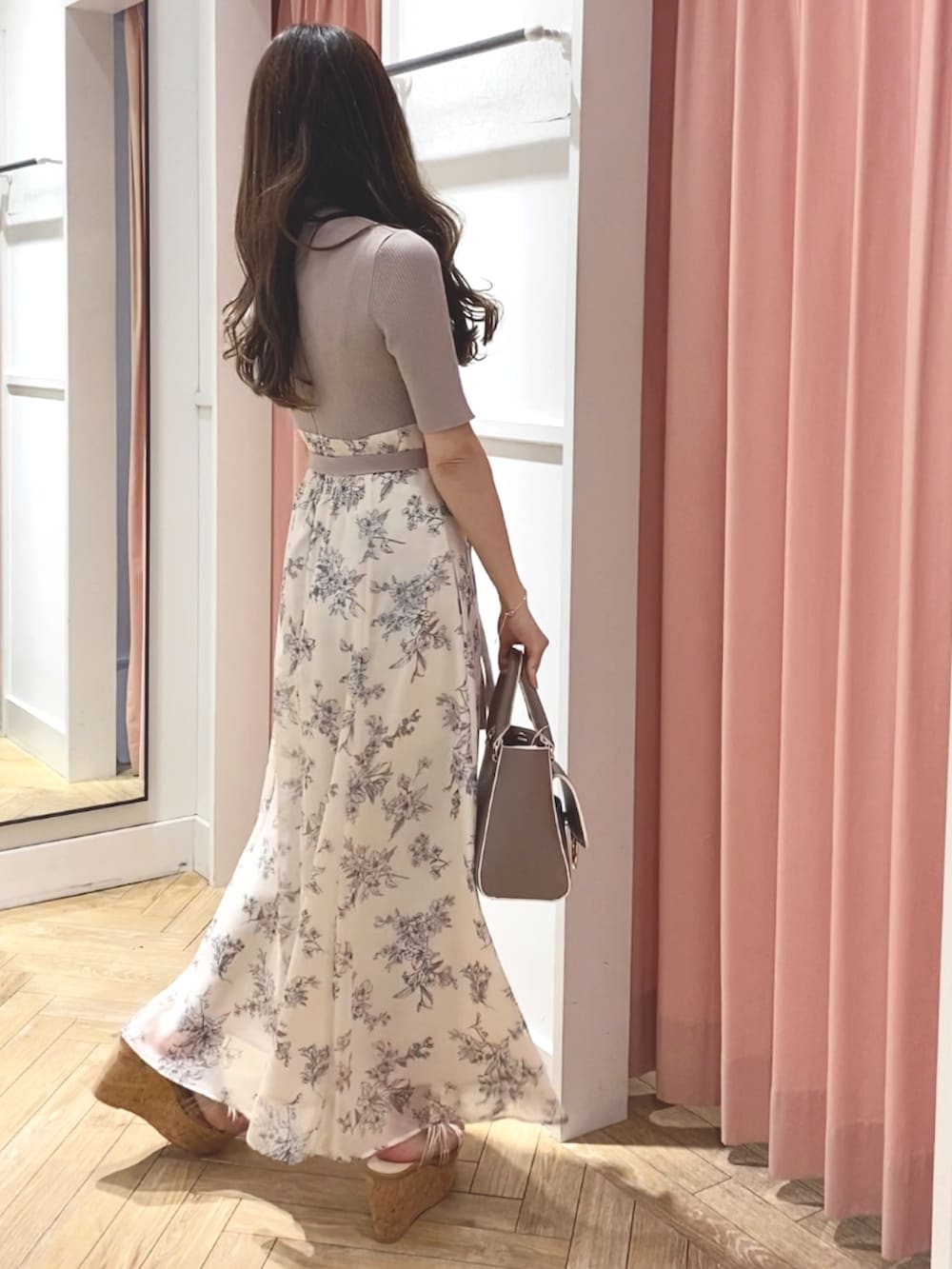 ホワイト系のサンダル、ベージュ系のハンドバッグ、ホワイト系のワンピースを着用したレディースの冬コーディネートの6枚目の写真