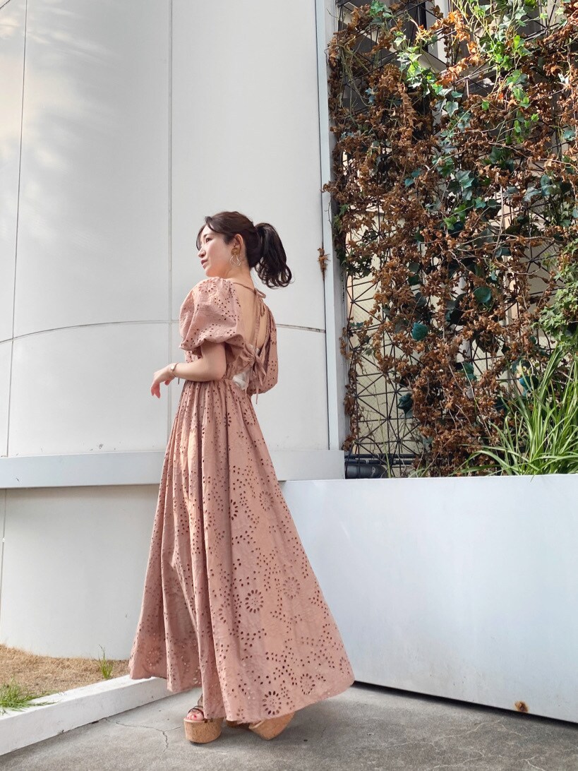 グリーン系のサンダル、ベージュ系のワンピースを着用したレディースの夏コーディネートの2枚目の写真