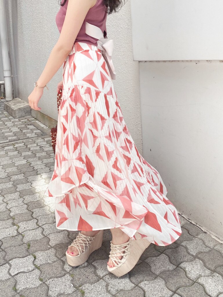 ホワイト系のサンダル、オレンジ系のスカート、ブラウン系のハンドバッグを着用したレディースの春コーディネートの3枚目の写真