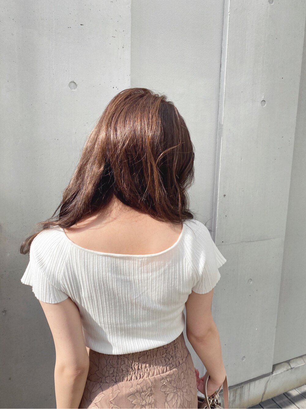 ブラウン系のスカート、ホワイト系のサンダル、ホワイト系のニット/セーターを着用したレディースの春コーディネートの4枚目の写真