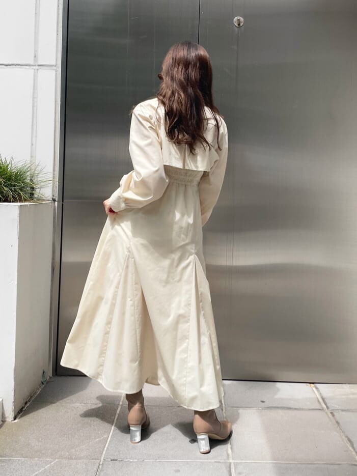 ベージュ系のブーツ、ホワイト系のハンドバッグ、ホワイト系のワンピースを着用したレディースの秋コーディネートの7枚目の写真