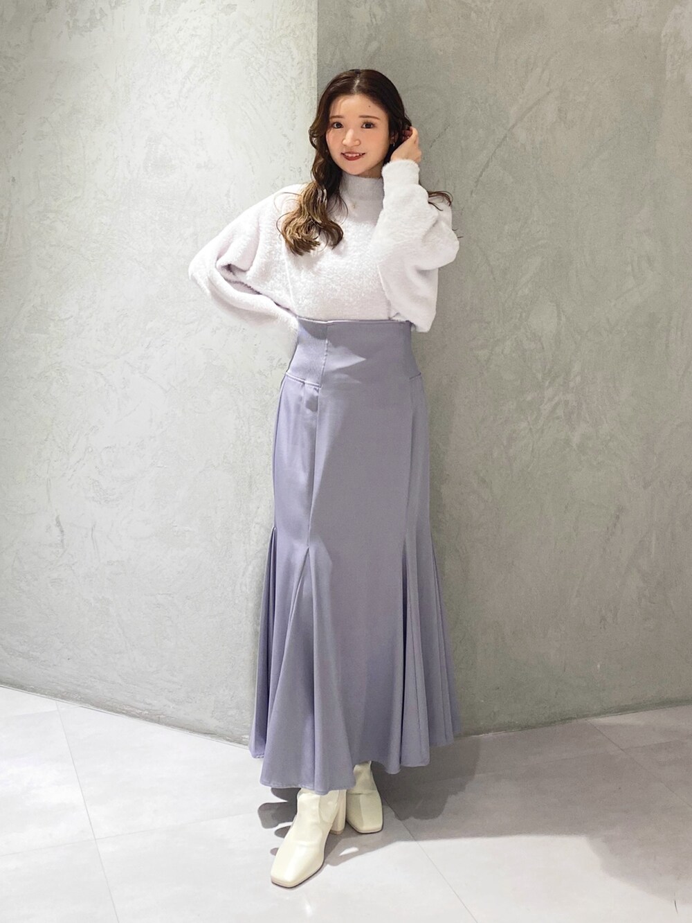 ホワイト系のブーツ、ブルー系のスカート、パープル系のニット/セーターを着用したレディースの秋コーディネートの6枚目の写真