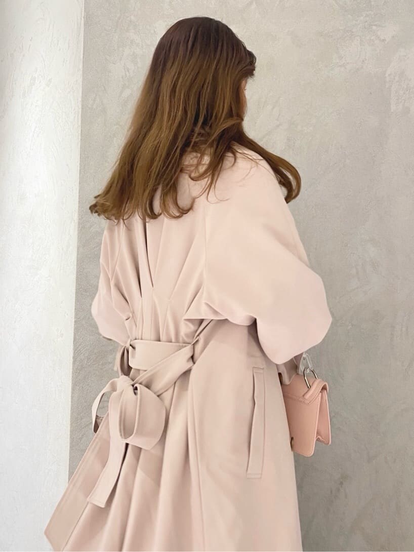 ピンク系のトレンチコートを着用したレディースの冬コーディネートの6枚目の写真