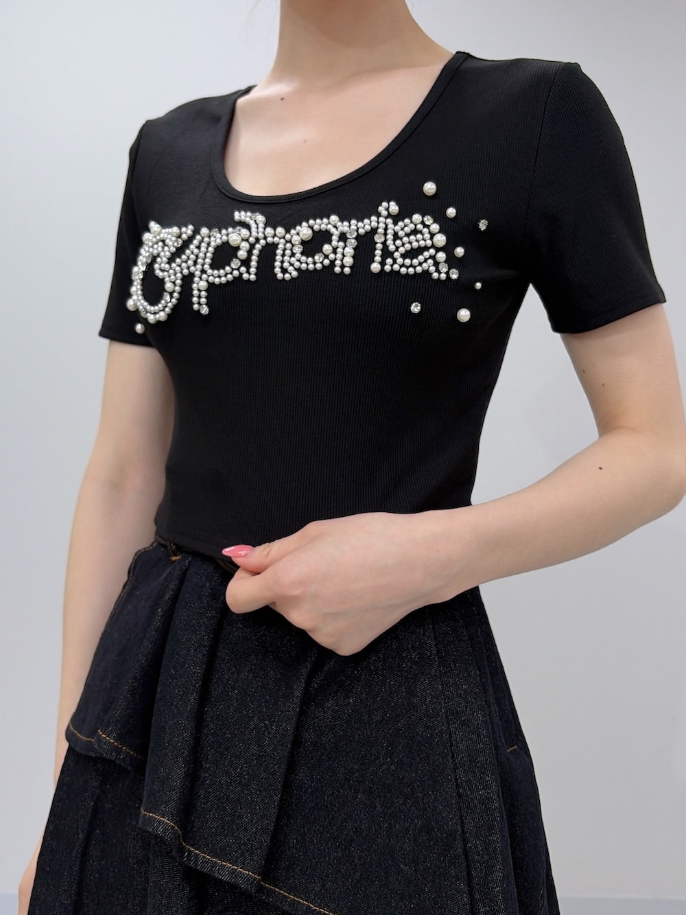 ブラック系のTシャツ/カットソー、ブラック系のスカート、ブラック系のサンダルを着用したレディースの夏コーディネートの5枚目の写真