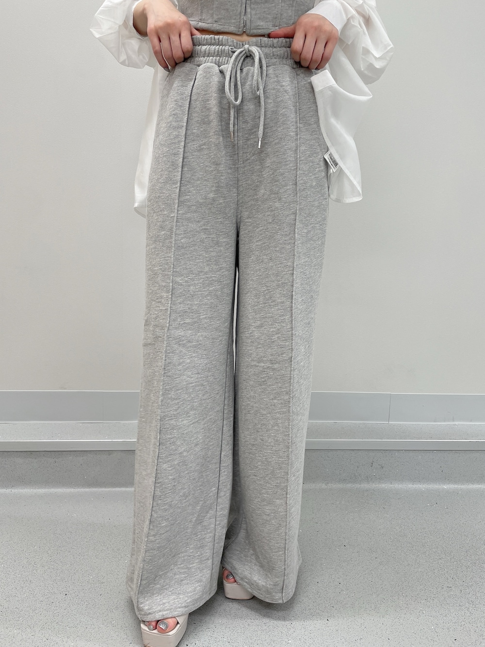 グレー系のタンクトップ、グレー系のスウェットパンツ、ホワイト系のシャツ/ブラウスを着用したレディースの春コーディネートの8枚目の写真
