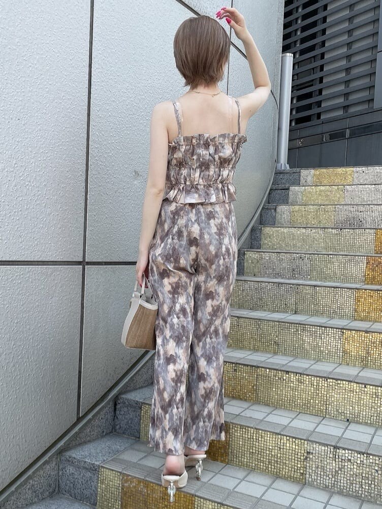 ベージュ系のハンドバッグ、ホワイト系のサンダル、ブルー系のその他パンツを着用したレディースの夏コーディネートの3枚目の写真