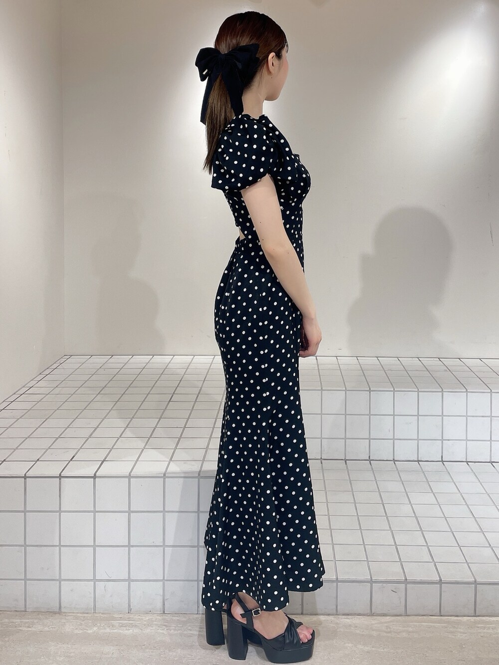 ブラック系のワンピース、ブラック系のサンダル、ブラック系のバレッタ/ヘアクリップを着用したレディースの春コーディネートの2枚目の写真