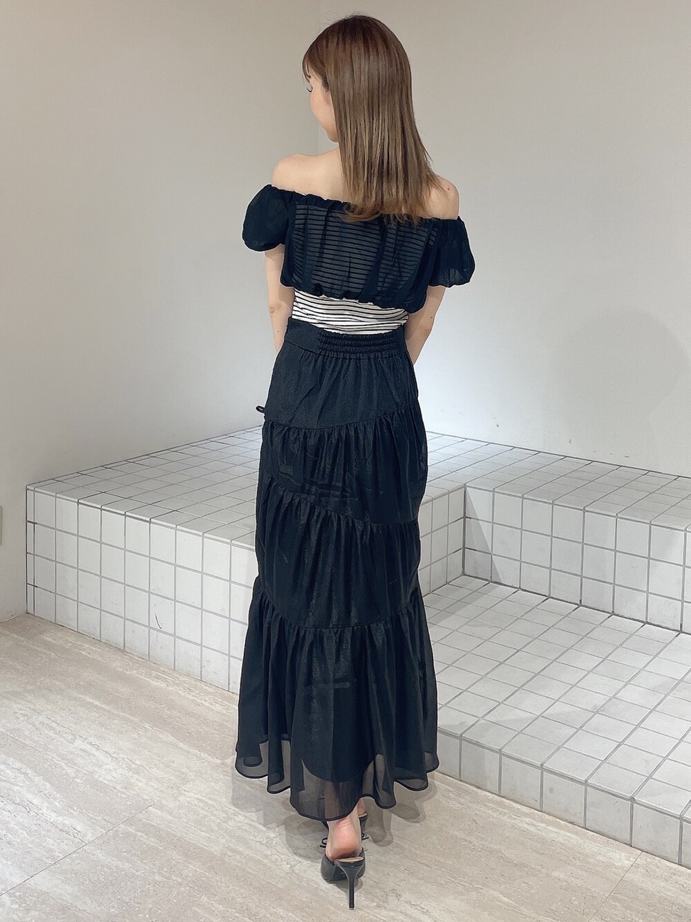 その他のTシャツ/カットソー、ブラック系のスカート、ブラック系のパンプスを着用したレディースの夏コーディネートの3枚目の写真