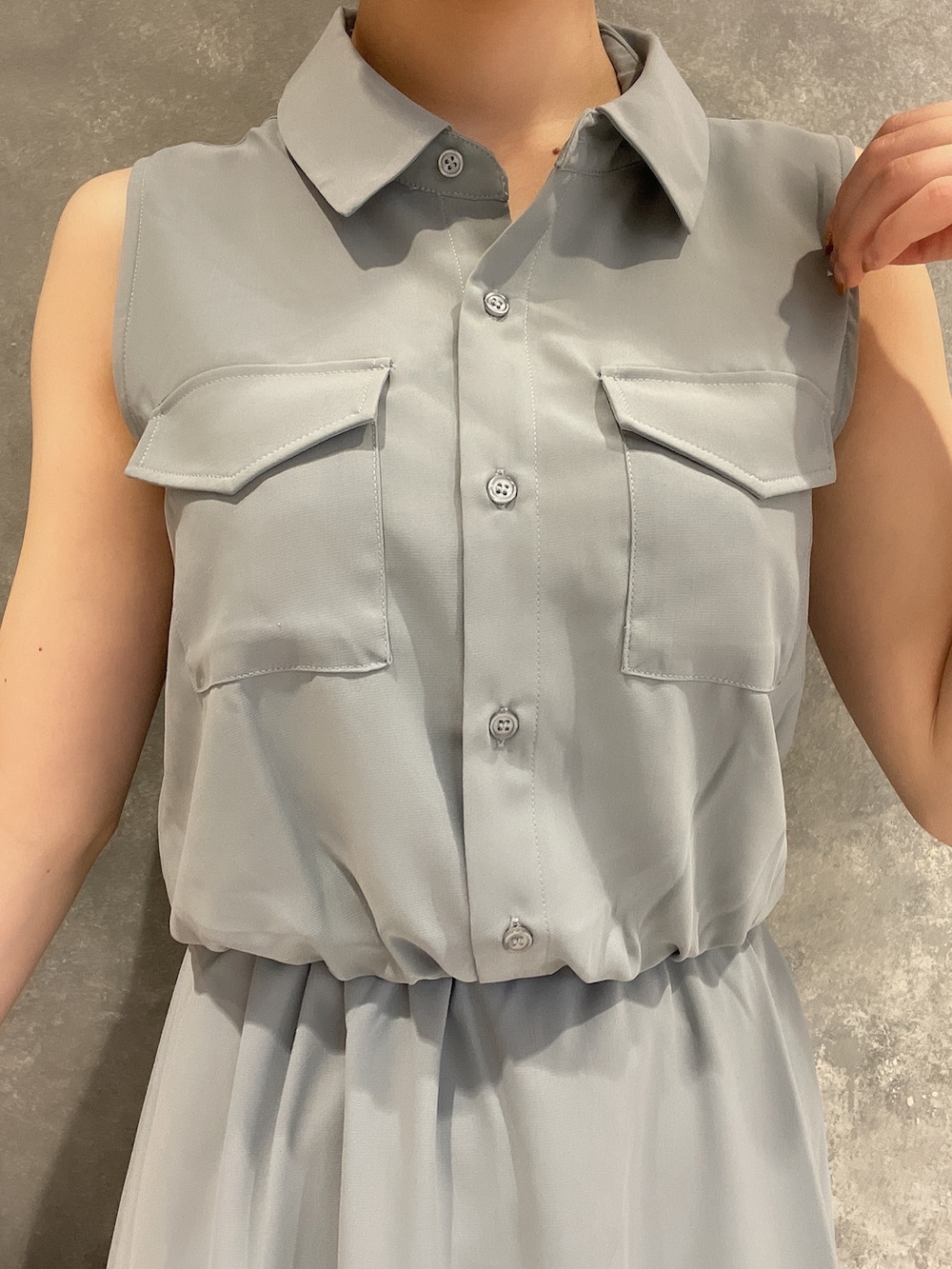 ホワイト系のハンドバッグ、ホワイト系のサンダル、ブルー系のシャツワンピースを着用したレディースの夏コーディネートの4枚目の写真