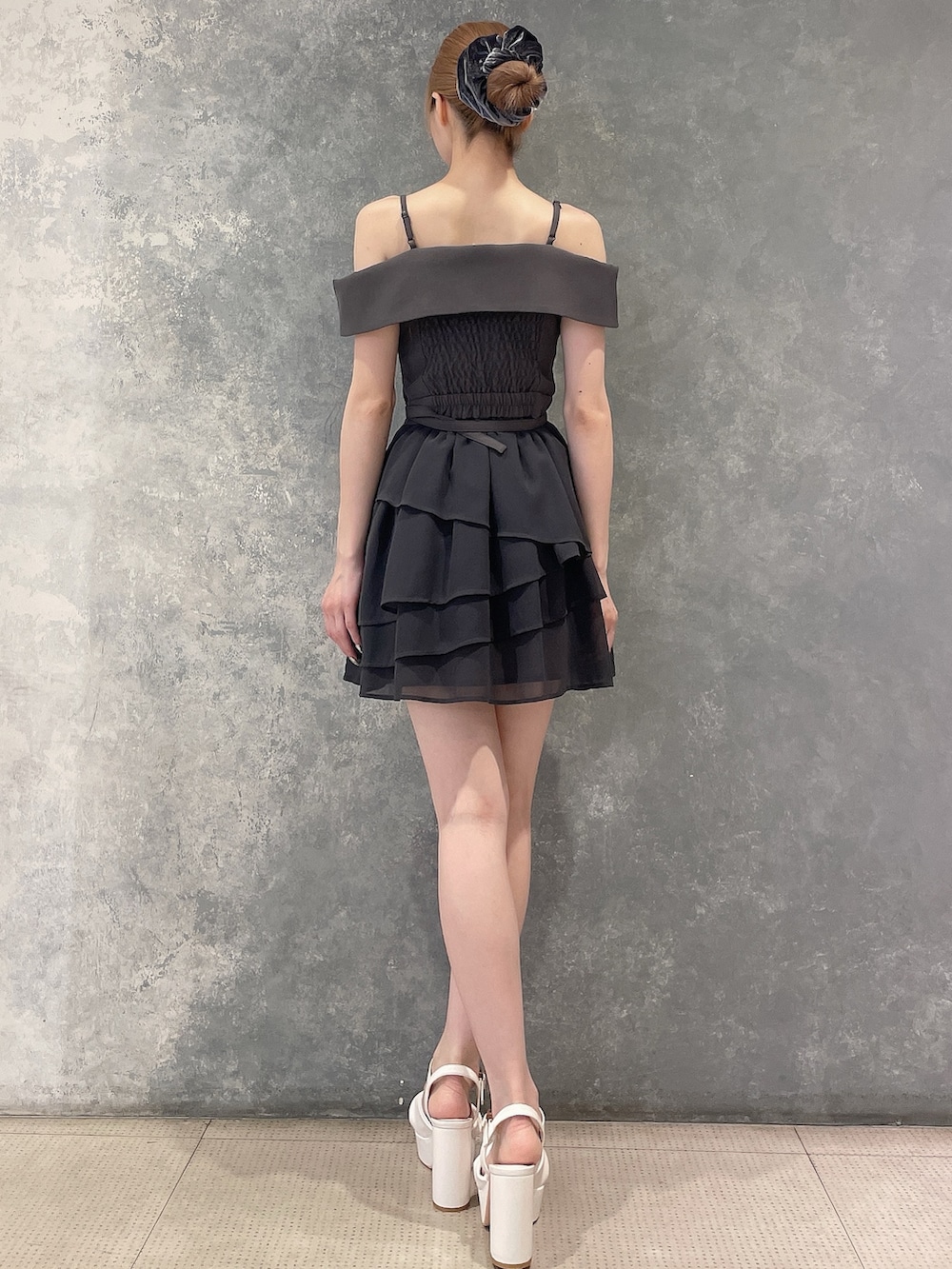 グレー系のワンピース、ホワイト系のサンダル、グレー系のシュシュを着用したレディースの夏コーディネートの6枚目の写真