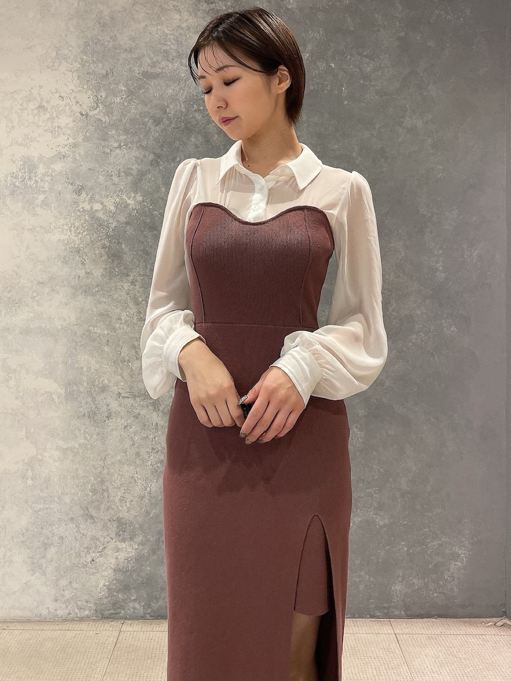 ブラック系のブーツ、ホワイト系のブルゾン、ブラウン系のワンピースを着用したレディースの秋コーディネートの9枚目の写真