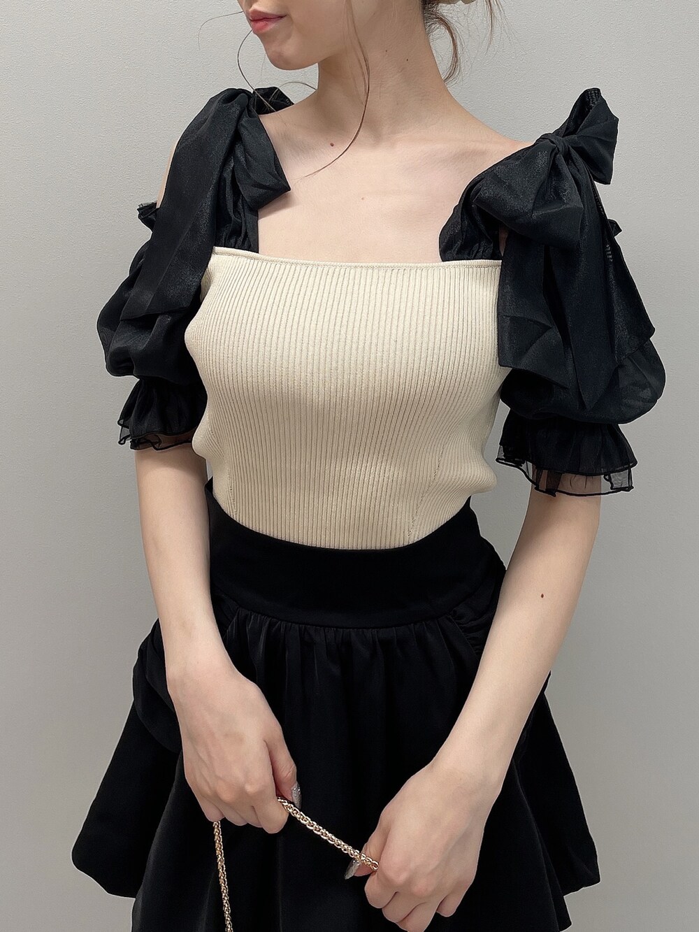 その他のニット/セーター、ブラック系のスカート、ホワイト系のショルダーバッグを着用したレディースの春コーディネートの5枚目の写真