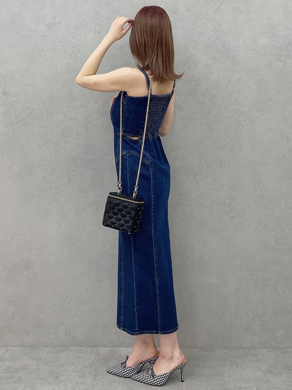 ブルー系のワンピース、ブラック系のショルダーバッグ、その他のパンプスを着用したレディースの冬コーディネートの5枚目の写真