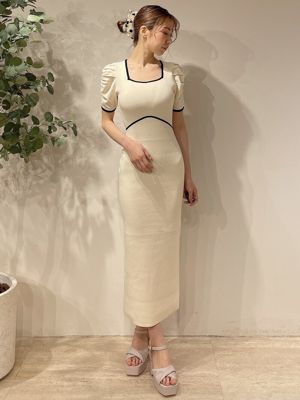 ホワイト系のライダースジャケット、ホワイト系のワンピース、ベージュ系のサンダルを着用したレディースの春コーディネートの5枚目の写真