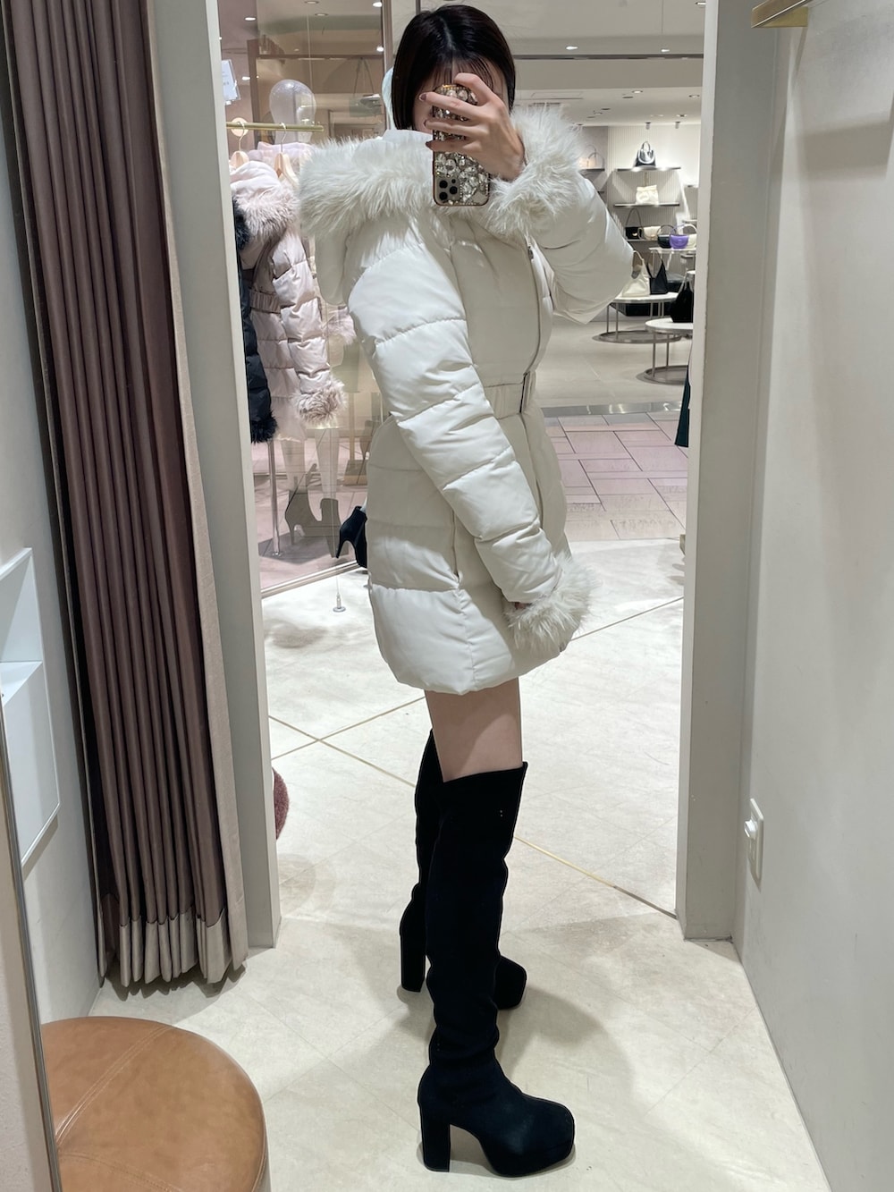 ホワイト系のダウンジャケット/コート、その他のワンピース、ブラック系のブーツを着用したレディースの秋コーディネートの6枚目の写真