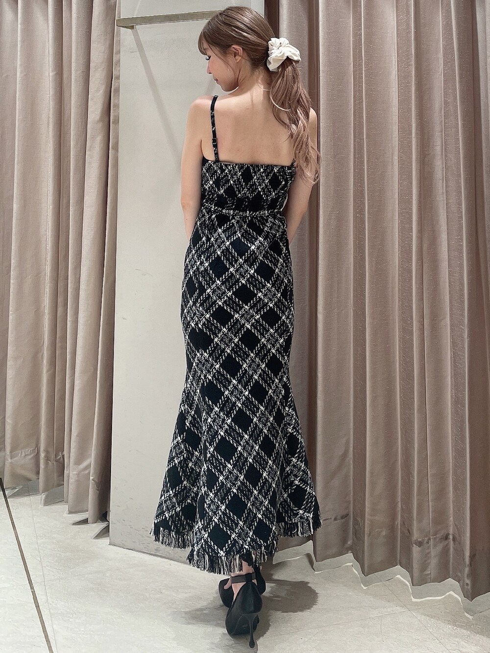 グレー系のカーディガン/ボレロ、ブラック系のワンピース、ブラック系のパンプスを着用したレディースの秋コーディネートの6枚目の写真