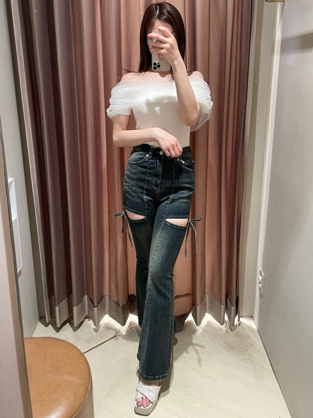 ホワイト系のニット/セーター、ブルー系のデニムパンツ、ベージュ系のサンダルを着用したレディースの春コーディネートの2枚目の写真