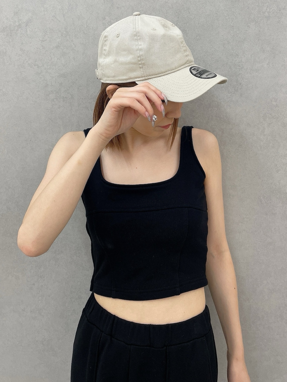 ブラック系のタンクトップ、ブラック系のスウェットパンツ、ブラック系のパンプスを着用したレディースの夏コーディネートの5枚目の写真