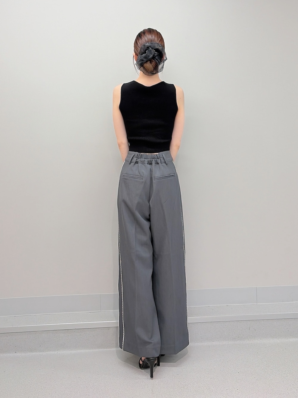 ブラック系のタンクトップ、グレー系のその他パンツ、ブラック系のサンダルを着用したレディースの夏コーディネートの3枚目の写真
