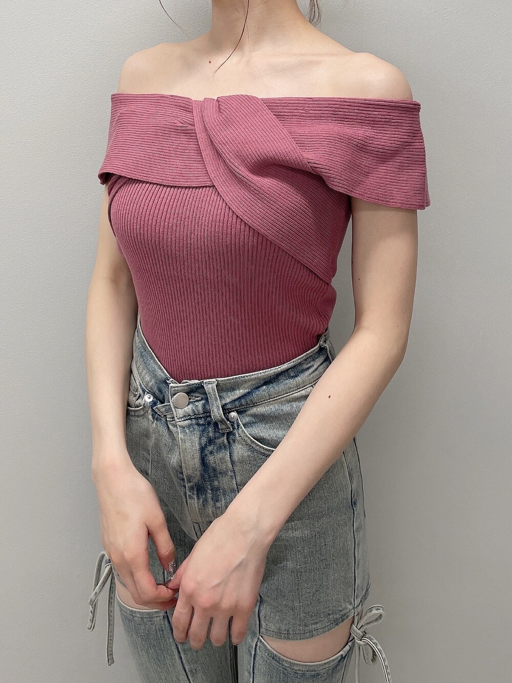 ピンク系のニット/セーター、ブルー系のデニムパンツ、ブラック系のサンダルを着用したレディースの春コーディネートの4枚目の写真