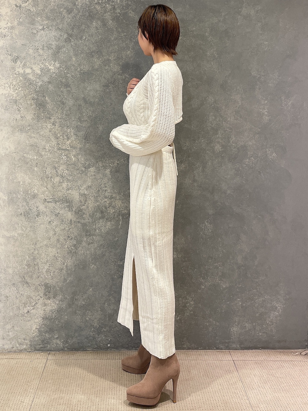 ベージュ系のブルゾン、ホワイト系のワンピース、ベージュ系のブーツを着用したレディースの秋コーディネートの7枚目の写真