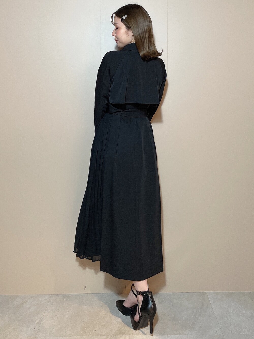 ブラック系のトレンチコート、ブラック系のパンプスを着用したレディースの冬コーディネートの5枚目の写真