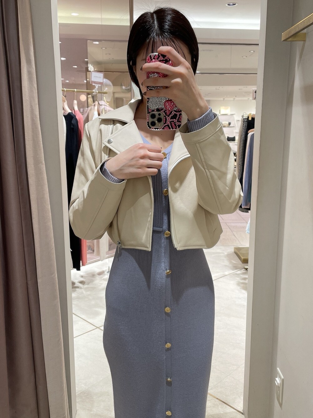 ホワイト系のパンプス、ブルー系のワンピース、ホワイト系のライダースジャケットを着用したレディースの冬コーディネートの7枚目の写真