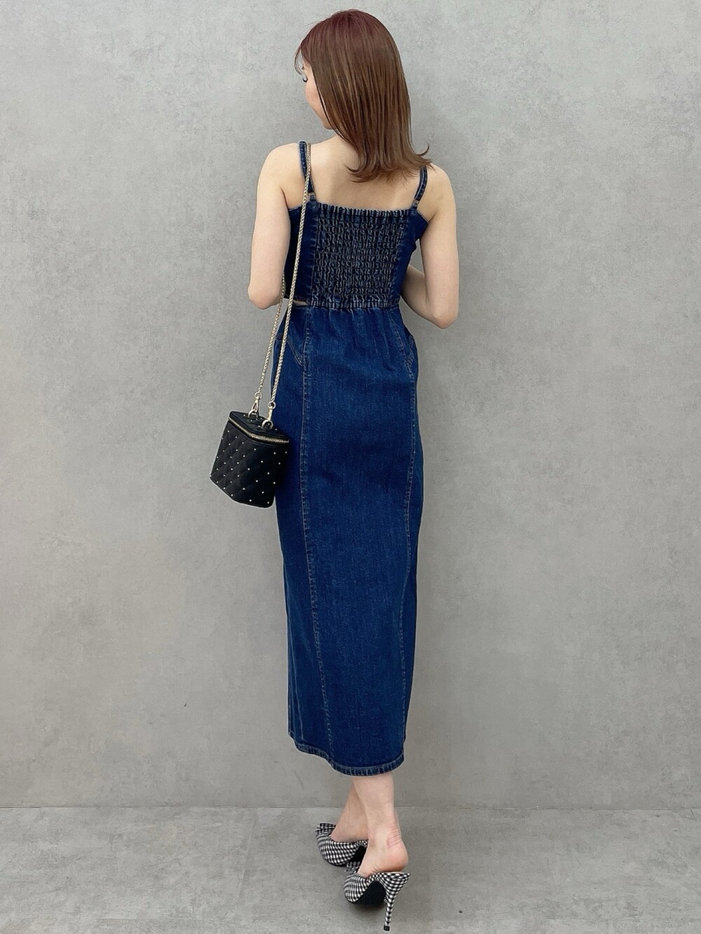 ブルー系のワンピース、ブラック系のショルダーバッグ、その他のパンプスを着用したレディースの冬コーディネートの4枚目の写真