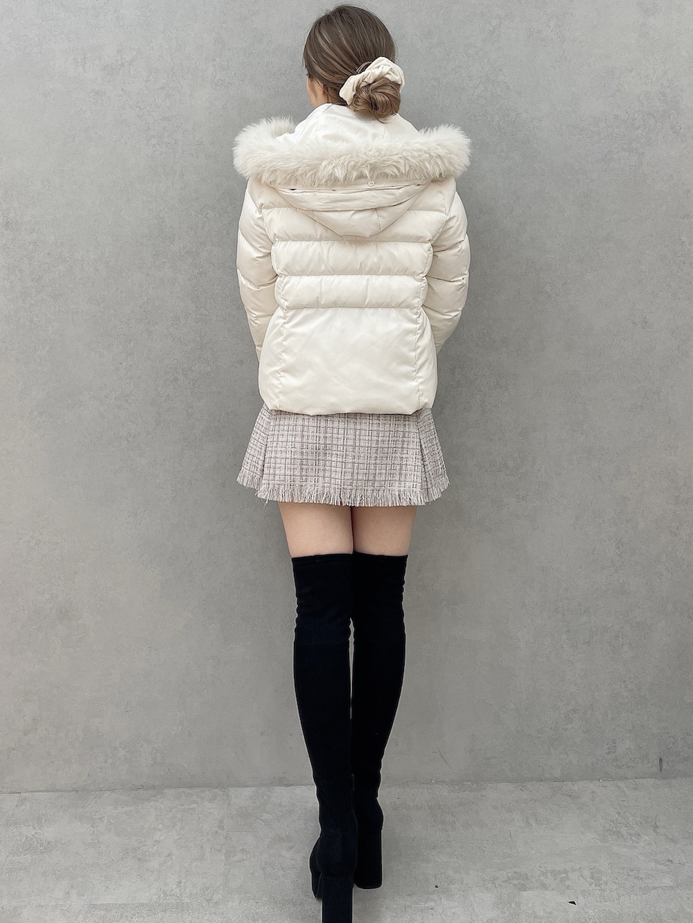 ホワイト系のダウンジャケット/コート、パープル系のスカート、ブラック系のブーツを着用したレディースの秋コーディネートの2枚目の写真