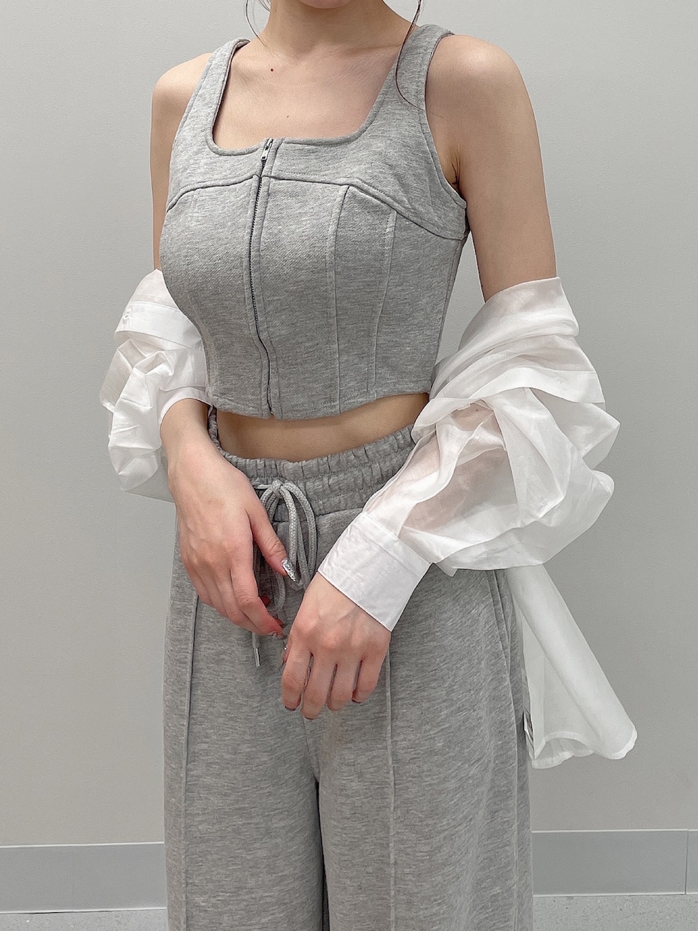 グレー系のタンクトップ、グレー系のスウェットパンツ、ホワイト系のシャツ/ブラウスを着用したレディースの春コーディネートの7枚目の写真