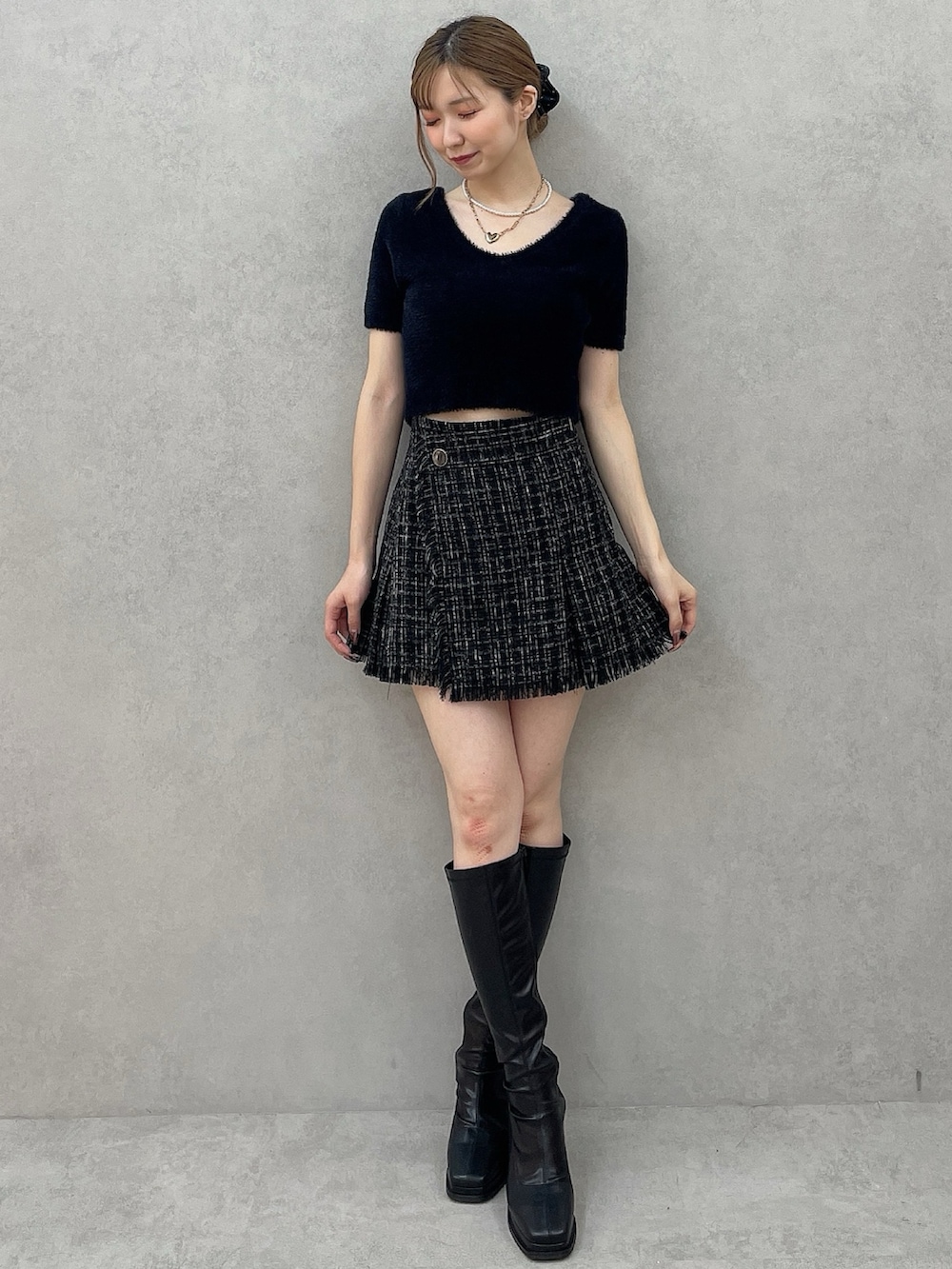 ブラック系のダウンジャケット/コート、ブラック系のニット/セーター、ブラック系のスカートを着用したレディースの夏コーディネートの7枚目の写真