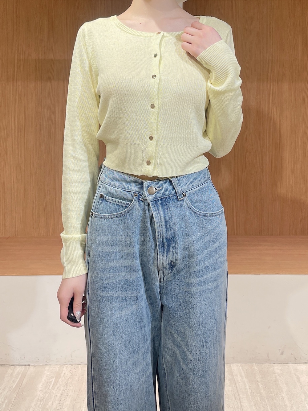 ホワイト系のテーラードジャケット、イエロー系のカーディガン/ボレロ、ブルー系のデニムパンツを着用したレディースの春コーディネートの9枚目の写真