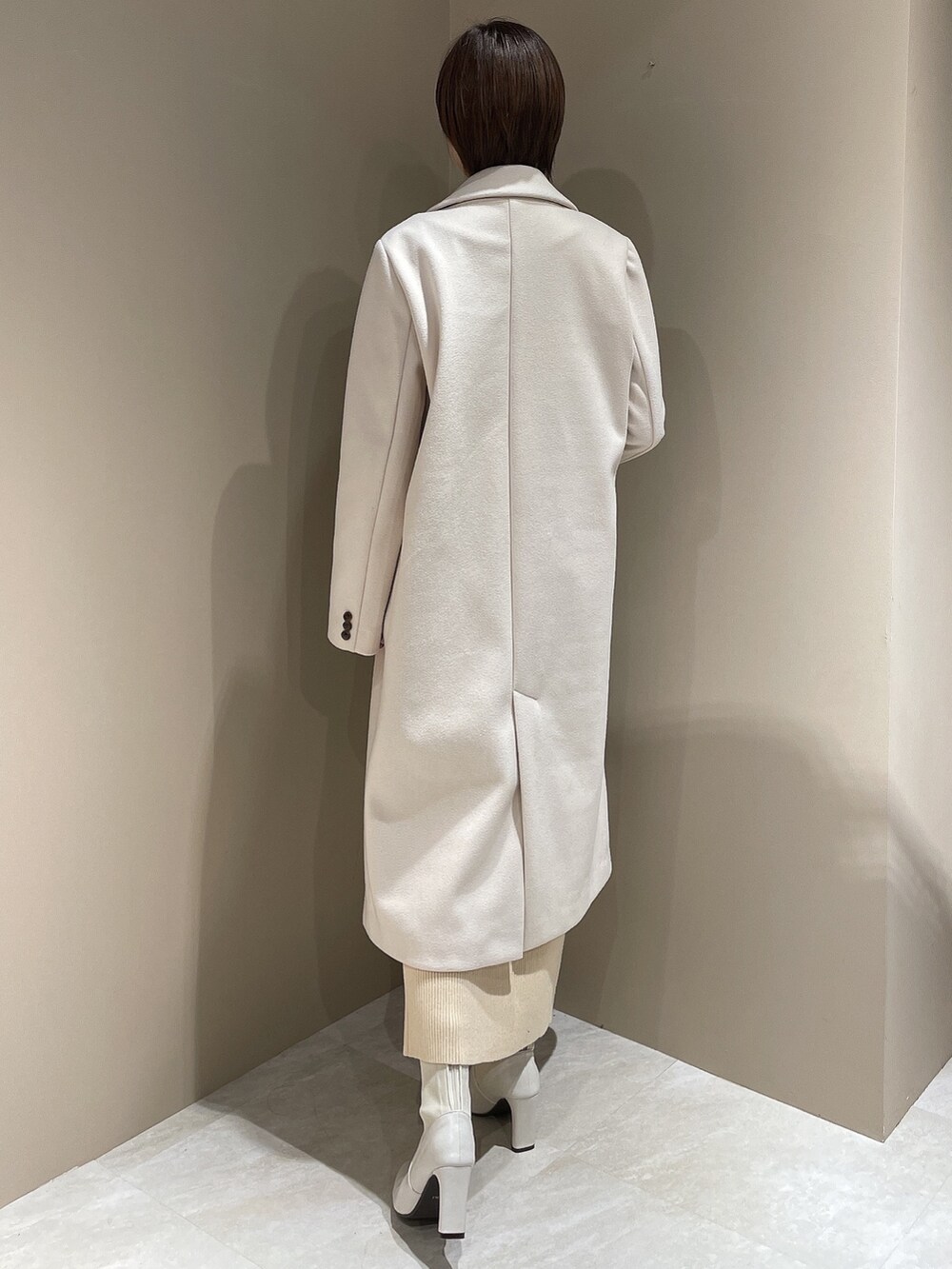 ホワイト系のチェスターコート、ホワイト系のブーツ、ホワイト系のワンピースを着用したレディースの夏コーディネートの5枚目の写真