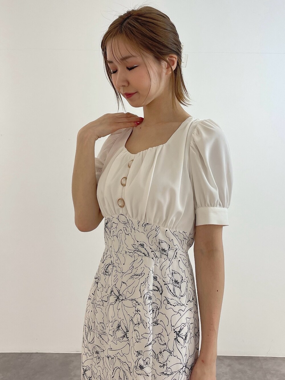 ホワイト系のワンピース、ホワイト系のハンドバッグ、ホワイト系のパンプスを着用したレディースの春コーディネートの5枚目の写真