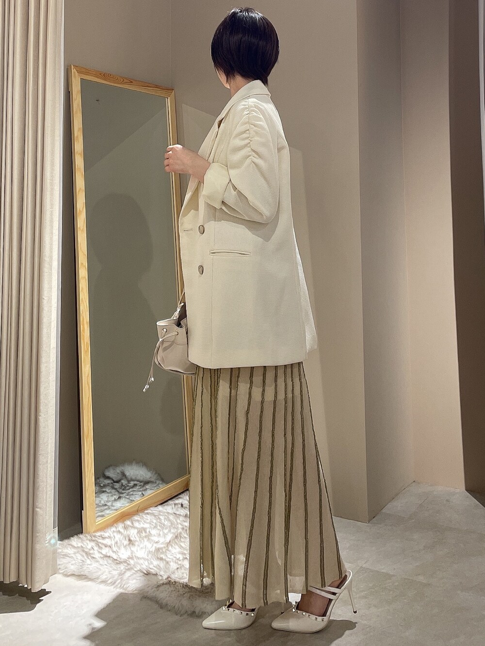 ホワイト系のテーラードジャケット、ホワイト系のワンピースを着用したレディースの春コーディネートの4枚目の写真