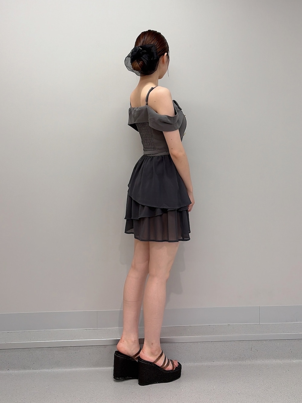 グレー系のワンピース、ブラック系のサンダル、ブラック系のシュシュを着用したレディースの夏コーディネートの5枚目の写真